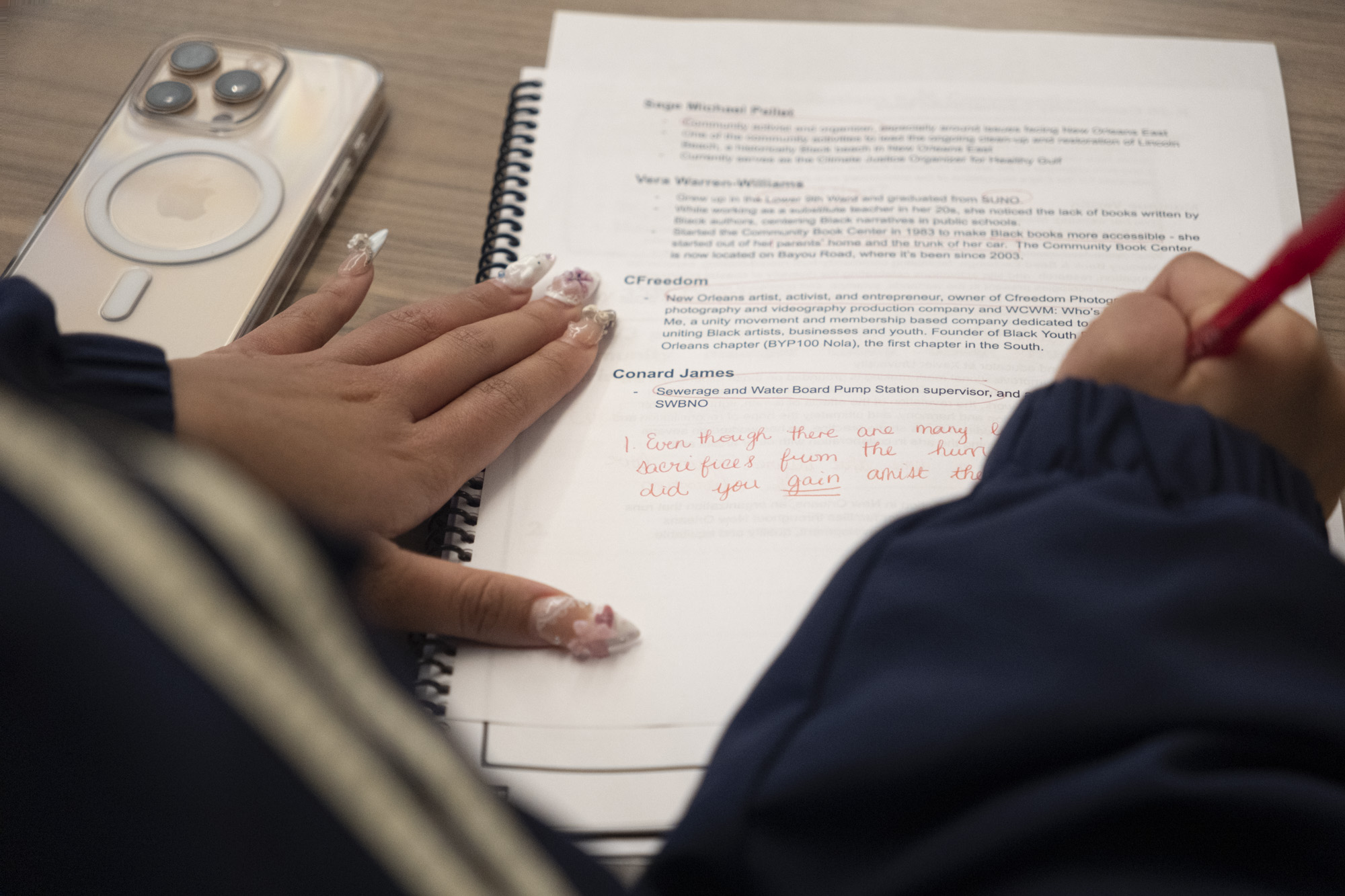 Hands writing story notes in a notebook