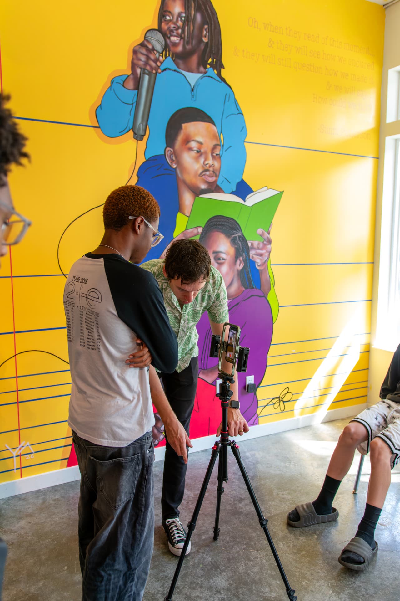 A youth media team setting up a phone camera
