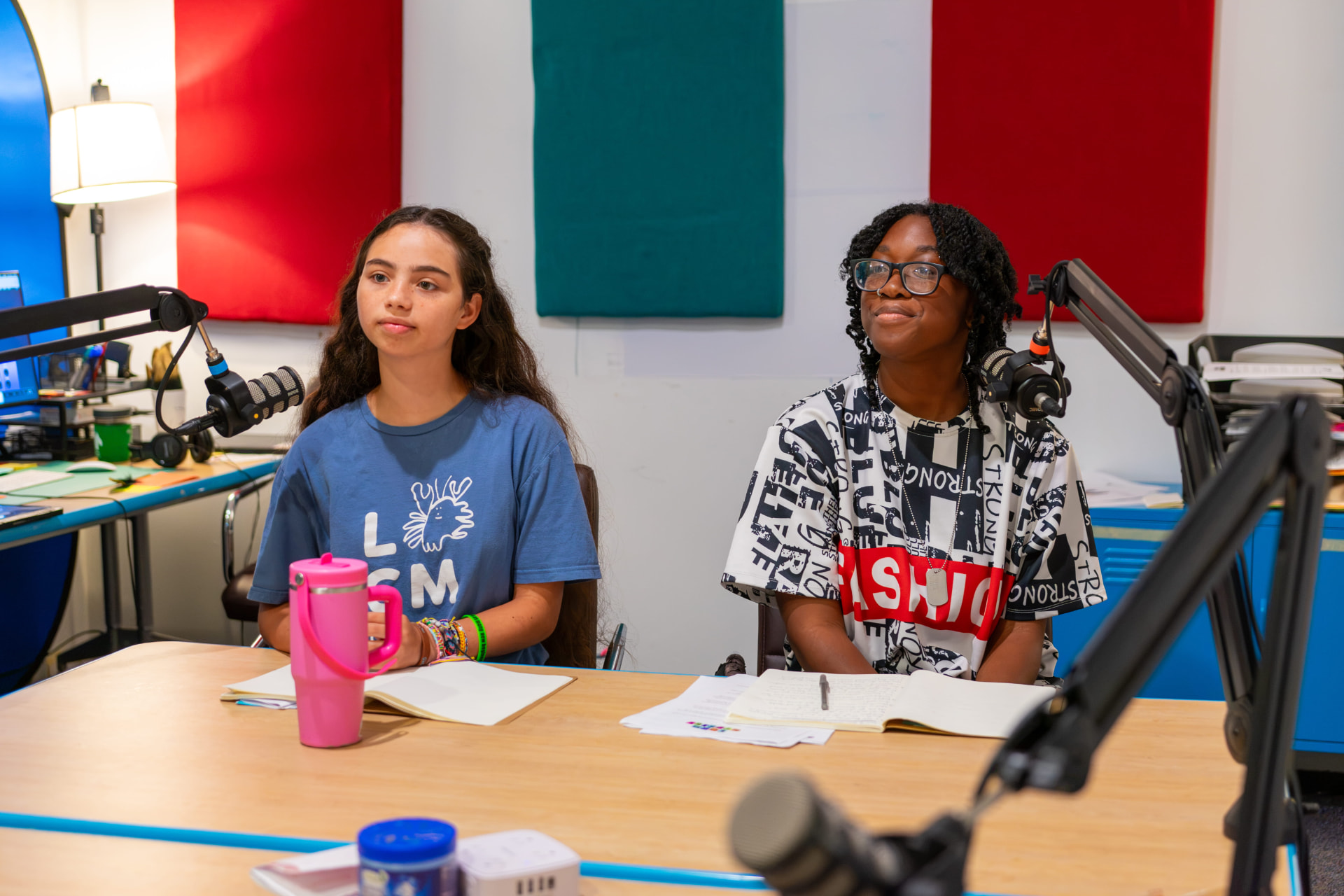 Two young hosts at studio microphones