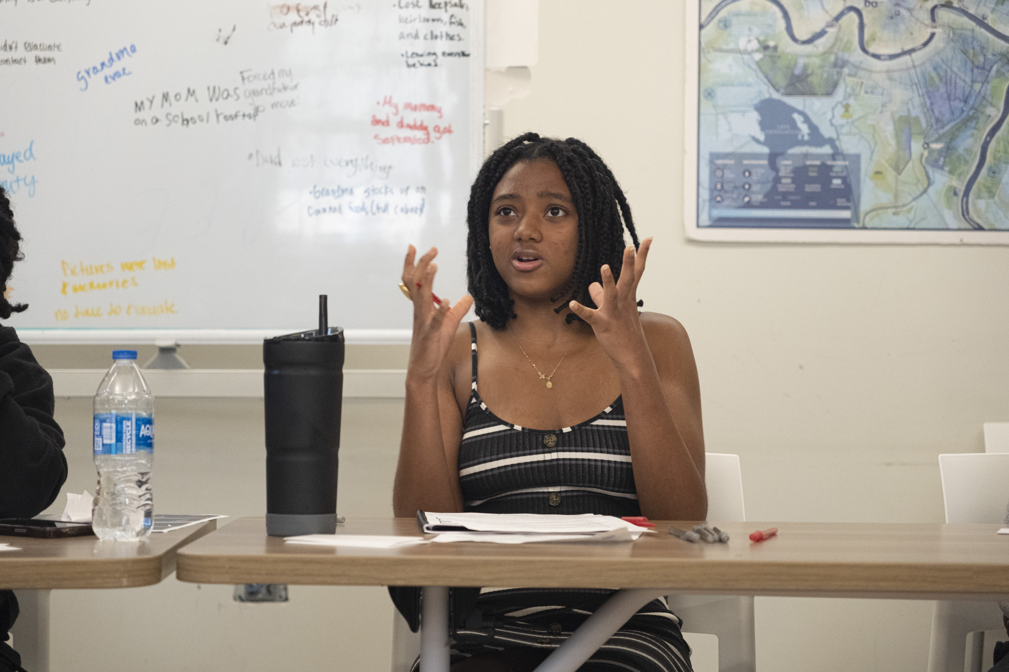 A young woman speaking with her hands raised during a storytelling workshop