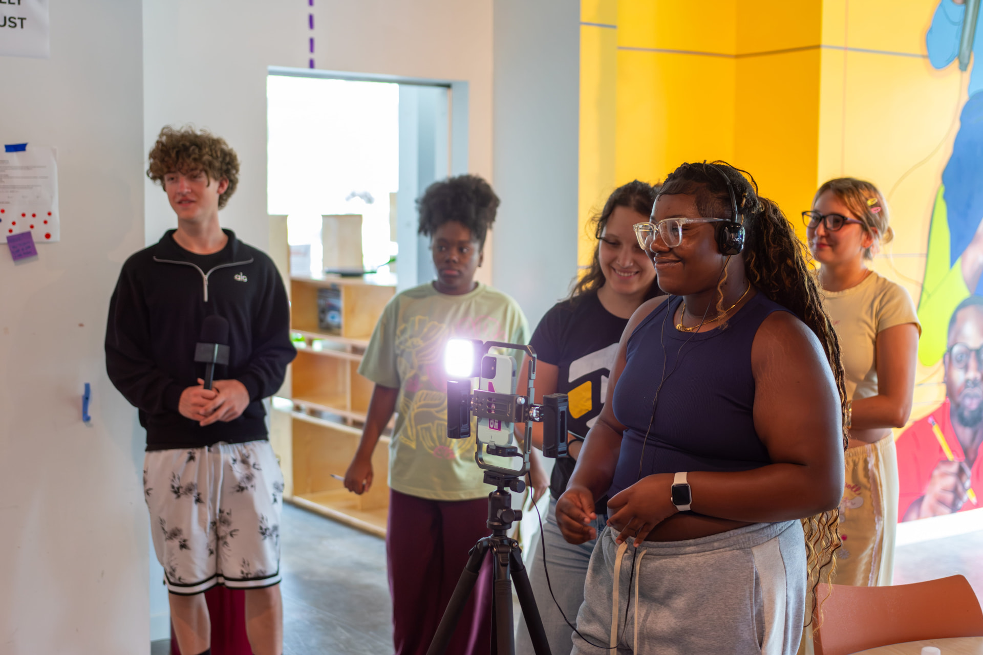 A crew of students filming a piece to camera