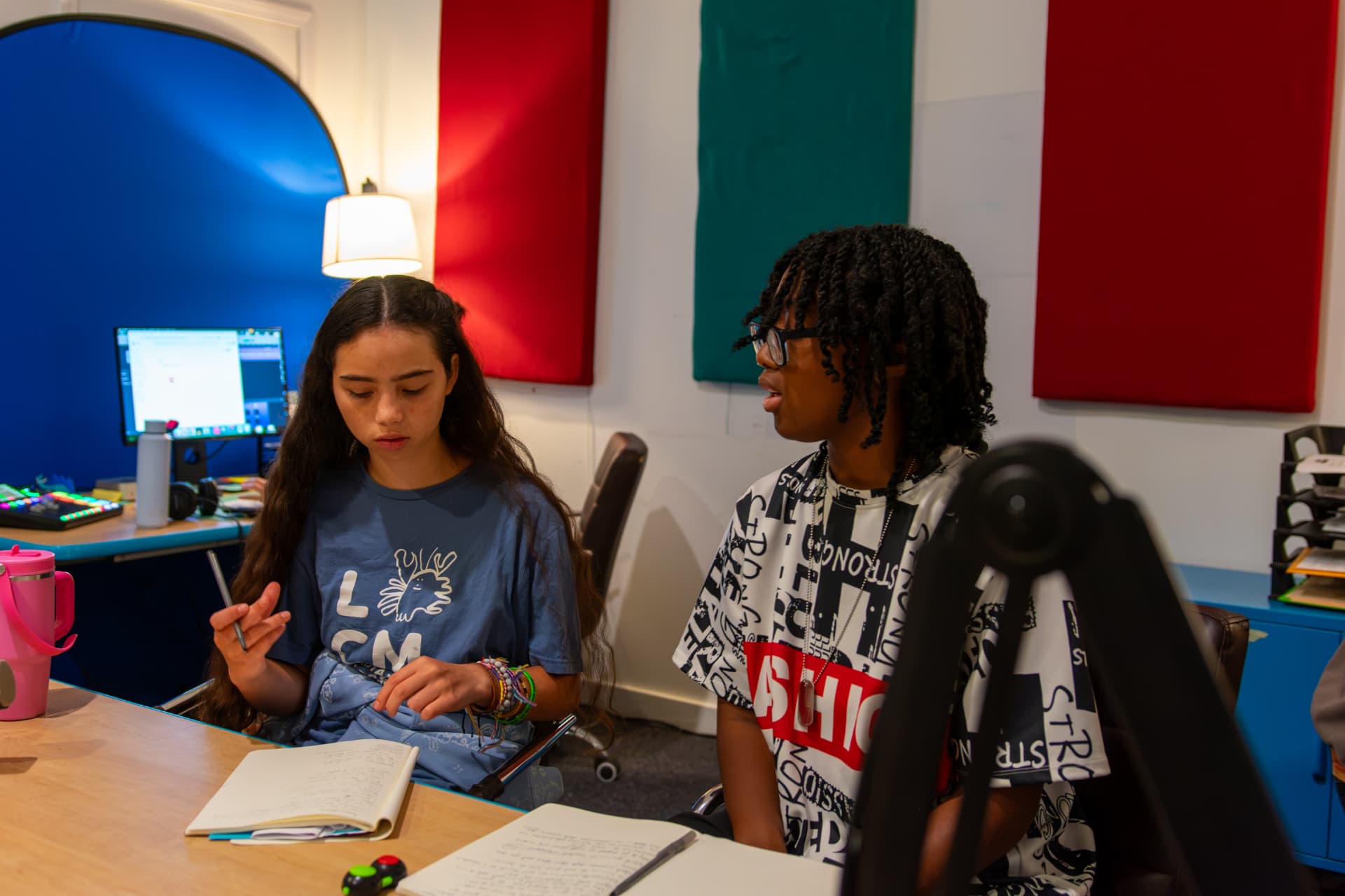 Two young people planning a story in the recording studio